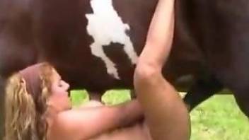 Blonde with natural boobs worships a stallion's cock