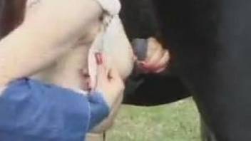 Redhead in denim sucking a black horse's meaty cock